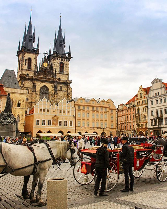 Prague Old Town Square with horse drawn carriages
